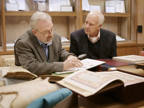 Steve and Del looking at a ancient text