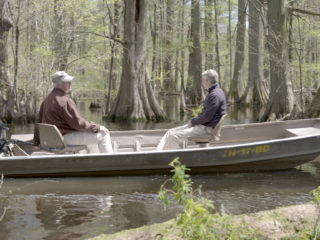 Stuart Burgess and Del Tackett in a boat on Reelfoot Lake